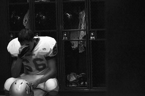 At halftime, Jacob Garza 12 sits on the bench in the locker room of Dragon Stadium, facing their first loss of the season. Garza, an offensive lineman, sits alone in the quiet as line backer, Paris Toler 12 yells, We did not come all the way over here to get our butts kicked. The frustration and dissapointment felt by Garza blocks all encouragement by his teammates. At 17-0, the possibilities of bringing in the first third consecutive win in 15 years seem slim.
Photo by John Morgan