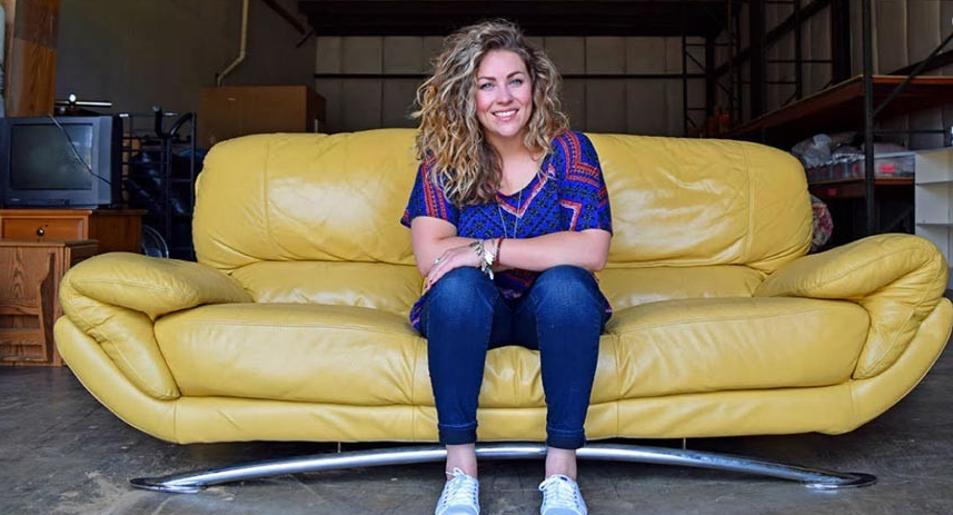 Founder Hope Mulkey sits on a couch donated to Furnished by Faith. Furniture drop off days are the second Saturday of each month. Submitted photo. Tiger Times online