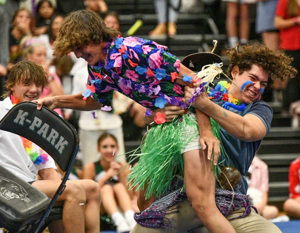 Feature Photo, Superior: David Gonzalez, 11, picks up Luca Gagliardi, 9, during the game of musical chairs during the first pep rally of the year. After Gonzalez threw Gagliardi to the gym floor, administrators stepped in and eliminated Gonzalez from the game.
