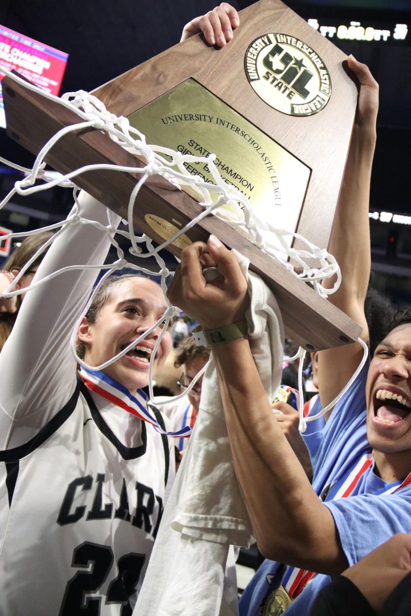 Sports Reaction Photo, Superior: Forward Kamryn Griffin yells with joy while holding the first 6A state championship trophy for Tom C. Clark High School. This is the second year in a row the Lady Cougars have competed at the state tournament. "My experience playing against DeSosto in the statefinals was a big deal to me," Griffin said. "Getting the opportunity to play on that big of a stage in front of my family and friends has been a dream of mine."